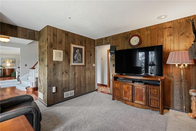 585 Taylor Dr, North Strabane, PA 15317 - living area featuring wood walls, light colored carpet, and stairs