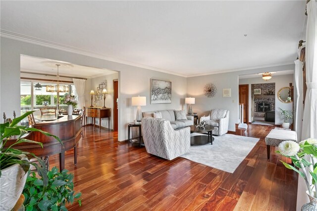 585 Taylor Dr, North Strabane, PA 15317 - living room featuring dark wood finished floors, crown molding, a chandelier, and a fireplace