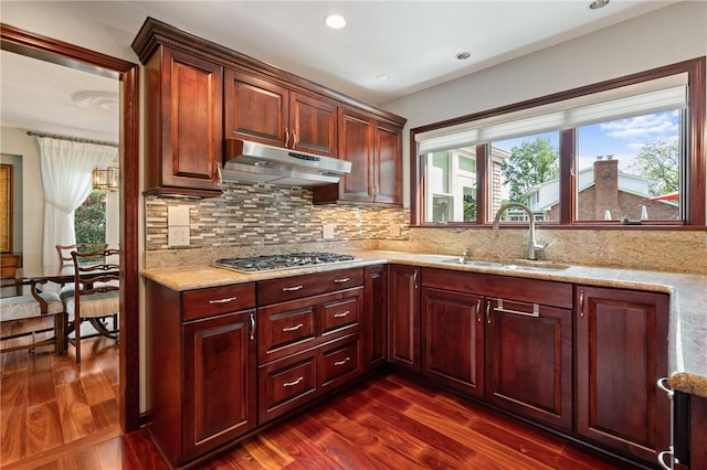 585 Taylor Dr, North Strabane, PA 15317 - kitchen featuring stainless steel gas cooktop, under cabinet range hood, dark wood-style flooring, light stone countertops, and backsplash