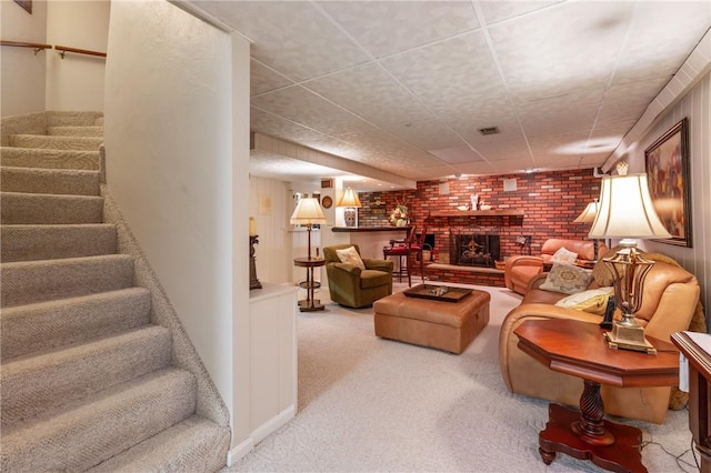 585 Taylor Dr, North Strabane, PA 15317 - carpeted living room featuring stairs, a brick fireplace, and brick wall