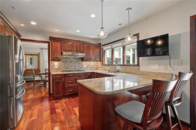 585 Taylor Dr, North Strabane, PA 15317 - kitchen featuring appliances with stainless steel finishes, a peninsula, dark wood-type flooring, under cabinet range hood, and light stone counters
