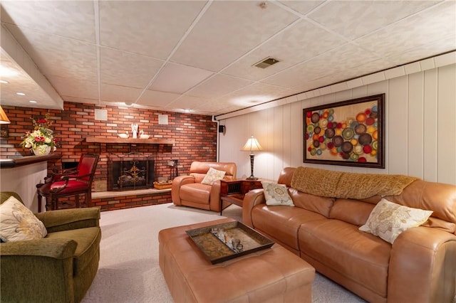 585 Taylor Dr, North Strabane, PA 15317 - living area featuring carpet, a drop ceiling, a brick fireplace, and brick wall