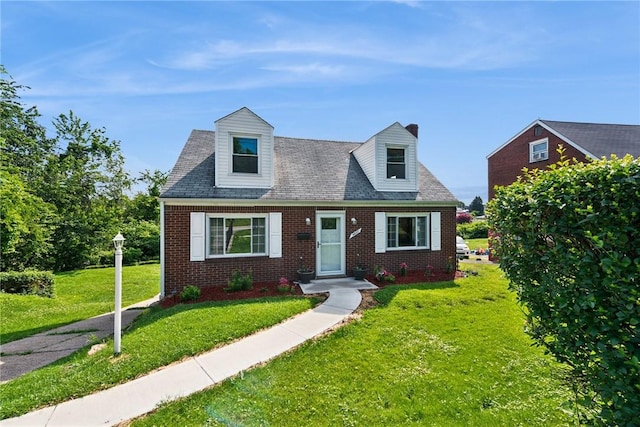 4057 Eliza St, West Mifflin, PA 15122 - new england style home featuring brick siding, a front lawn, and a chimney