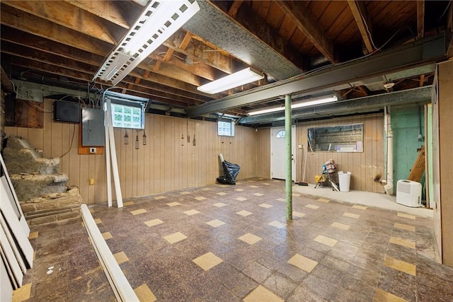 4057 Eliza St, West Mifflin, PA 15122 - basement featuring electric panel, wood walls, tile patterned floors, and stairway