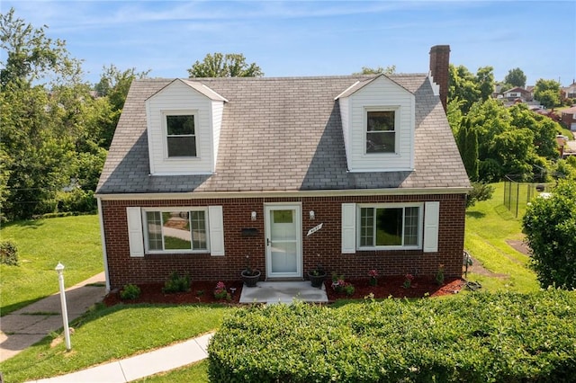 4057 Eliza St, West Mifflin, PA 15122 - cape cod home featuring brick siding, a chimney, and a front lawn