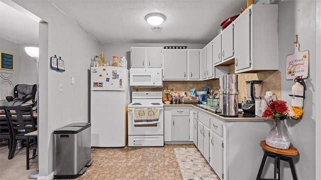 117 Carroll St, Aliquippa, PA 15001 - kitchen featuring white appliances, white cabinetry, and a textured ceiling
