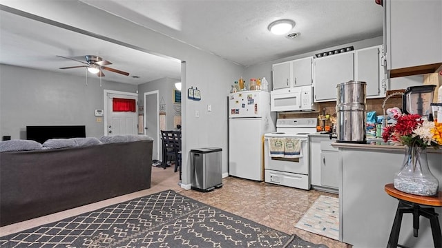 117 Carroll St, Aliquippa, PA 15001 - kitchen with white appliances, ceiling fan, white cabinetry, and tasteful backsplash