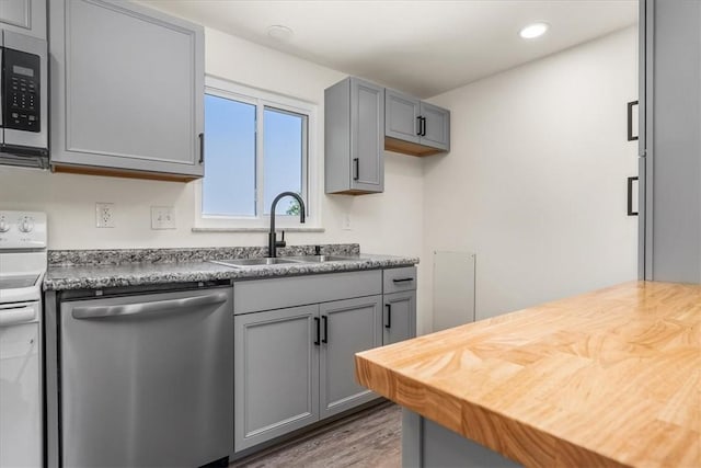 118 Farmcrest Dr, North Fayette, PA 15071 - kitchen with stainless steel dishwasher, gray cabinets, white range with electric stovetop, wood finished floors, and recessed lighting