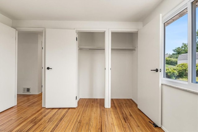 118 Farmcrest Dr, North Fayette, PA 15071 - unfurnished bedroom featuring multiple closets and light wood-style flooring