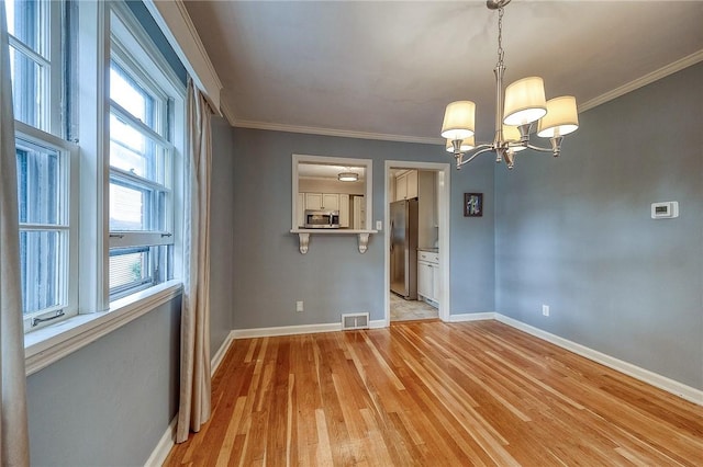 6833 Meade St Unit 17, Point Breeze, PA 15208 - unfurnished dining area featuring light wood-type flooring, a chandelier, and ornamental molding