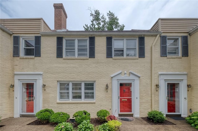 6833 Meade St Unit 17, Point Breeze, PA 15208 - view of property featuring a chimney and brick siding