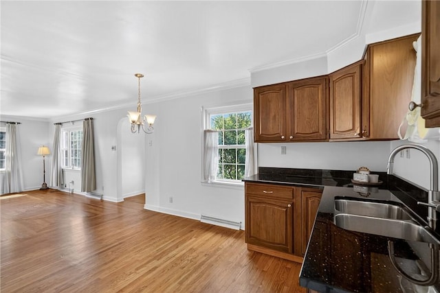 17 Fremont Rd, Pa, PA 15022 - kitchen with a chandelier, light wood-style flooring, ornamental molding, open floor plan, and brown cabinetry