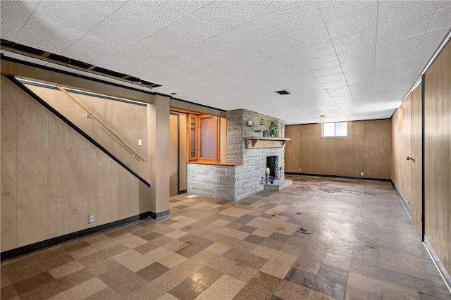 17 Fremont Rd, Pa, PA 15022 - below grade area featuring wood walls, a fireplace, stairs, and tile patterned floors