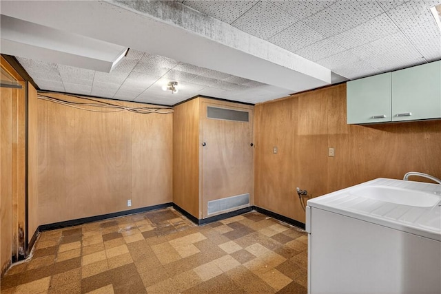 17 Fremont Rd, Pa, PA 15022 - laundry area featuring washer / clothes dryer, cabinet space, tile patterned floors, and wooden walls
