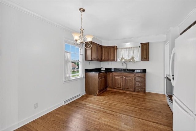 17 Fremont Rd, Pa, PA 15022 - kitchen featuring freestanding refrigerator, dark countertops, a chandelier, range, and light wood finished floors