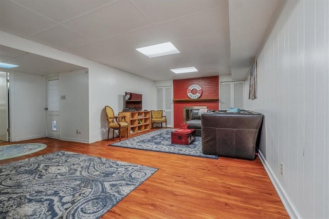1230 Northwestern Dr, Monroeville, PA 15146 - living room featuring a fireplace, wood finished floors, and a paneled ceiling