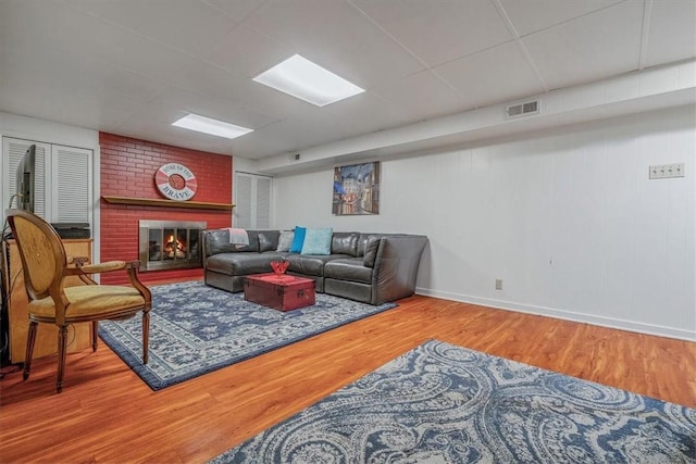 1230 Northwestern Dr, Monroeville, PA 15146 - living area with wood finished floors, a brick fireplace, and a paneled ceiling