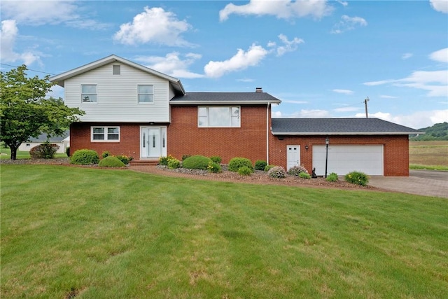 207 State Park Rd, New Alexandria, PA 15670 - split level home with an attached garage, brick siding, a front lawn, and driveway