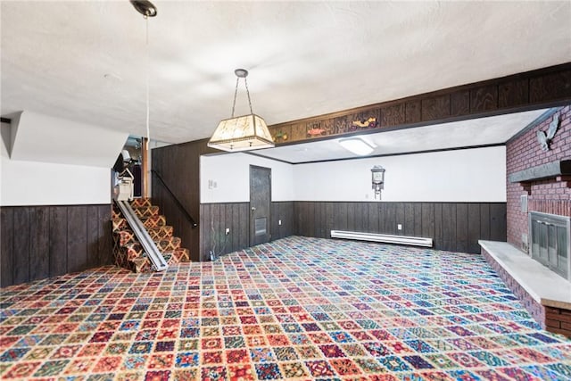 207 State Park Rd, New Alexandria, PA 15670 - kitchen featuring a baseboard radiator, a wainscoted wall, carpet floors, wooden walls, and hanging light fixtures