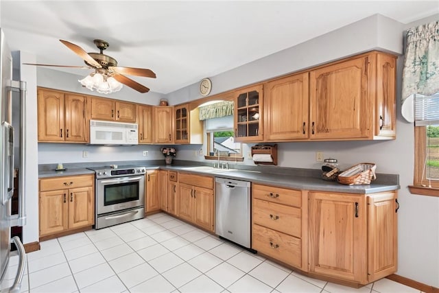 207 State Park Rd, New Alexandria, PA 15670 - kitchen featuring stainless steel appliances, healthy amount of natural light, ceiling fan, and glass insert cabinets