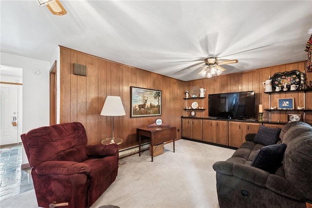207 State Park Rd, New Alexandria, PA 15670 - living area with wooden walls, a baseboard heating unit, and a ceiling fan