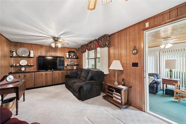 207 State Park Rd, New Alexandria, PA 15670 - living room featuring a ceiling fan, light carpet, and wood walls