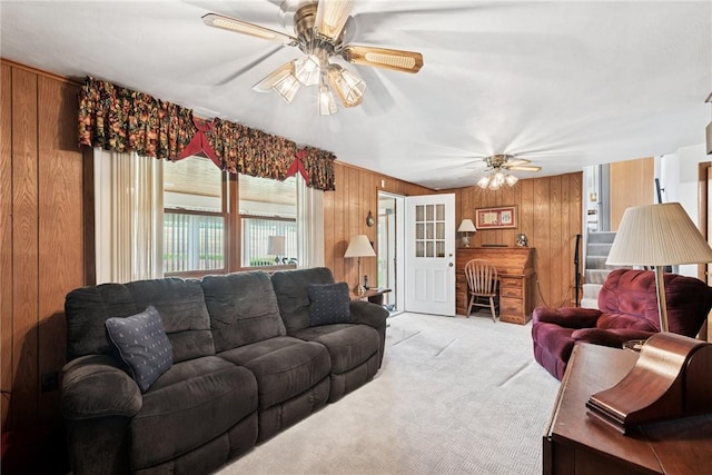207 State Park Rd, New Alexandria, PA 15670 - living room with wood walls, a ceiling fan, and light carpet