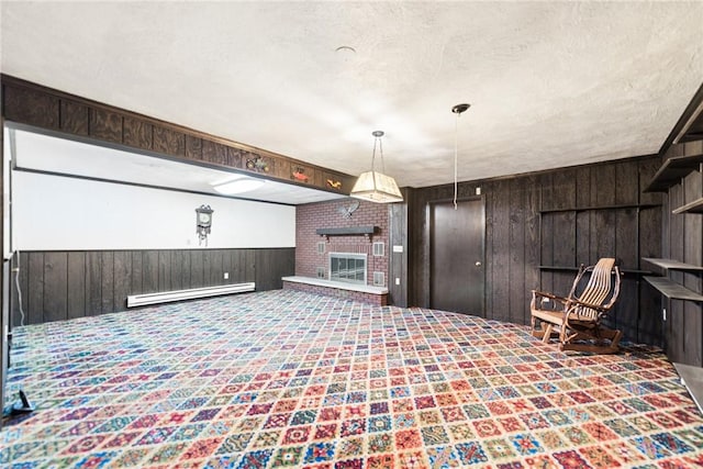 207 State Park Rd, New Alexandria, PA 15670 - living area featuring baseboard heating, wooden walls, a fireplace, carpet flooring, and a wainscoted wall