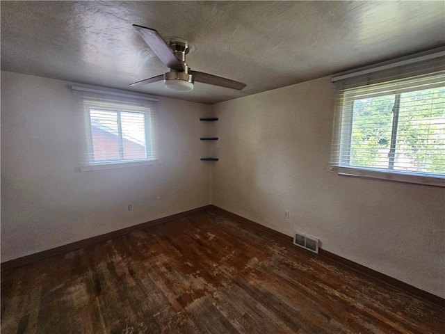 4235 Willow Ave, Castle Shannon, PA 15234 - empty room with a ceiling fan, healthy amount of natural light, dark wood finished floors, and a textured ceiling