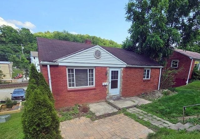 4235 Willow Ave, Castle Shannon, PA 15234 - view of front facade with brick siding, a front lawn, and a patio area