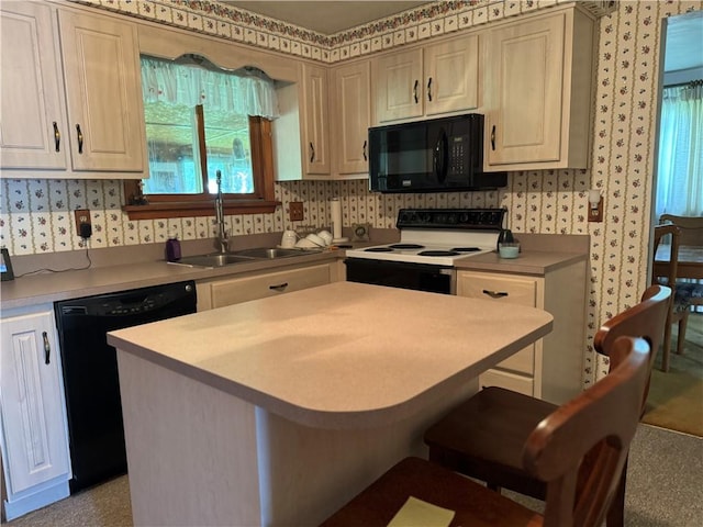 1306 Spring St, Derry Twp, PA 15650 - kitchen with black appliances, wallpapered walls, light countertops, a kitchen island, and a breakfast bar