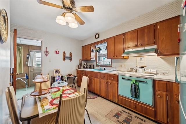 340 Weldon St, Latrobe, PA 15650 - kitchen with under cabinet range hood, plenty of natural light, light countertops, and range