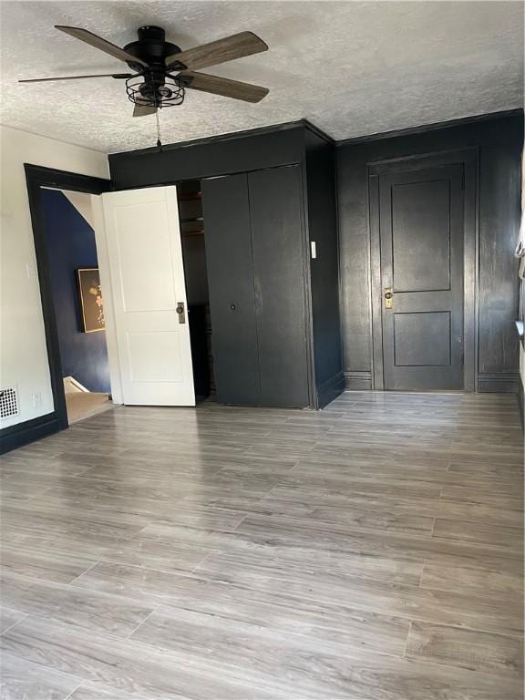 1022 Dewey Ave, New Castle/3Rd, PA 16101 - unfurnished bedroom featuring a textured ceiling, light wood-style floors, and ceiling fan