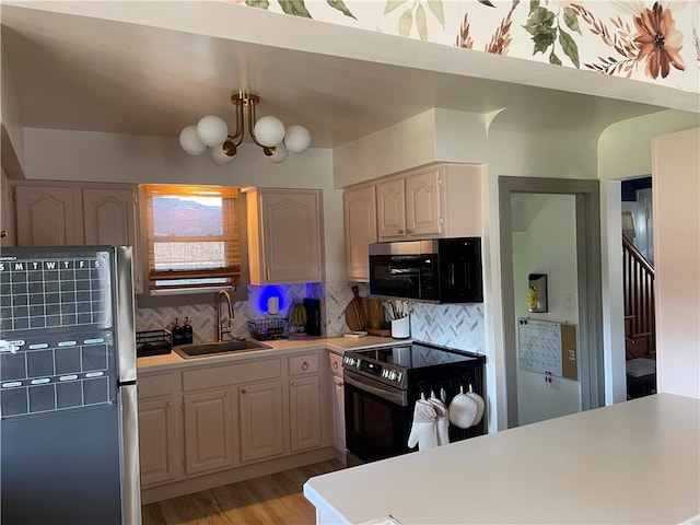 1022 Dewey Ave, New Castle/3Rd, PA 16101 - kitchen with stainless steel appliances, light countertops, backsplash, and a chandelier