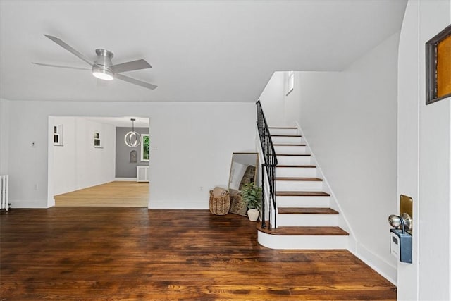 7032 Reynolds St, Point Breeze, PA 15208 - entryway with radiator heating unit, stairs, wood finished floors, and ceiling fan