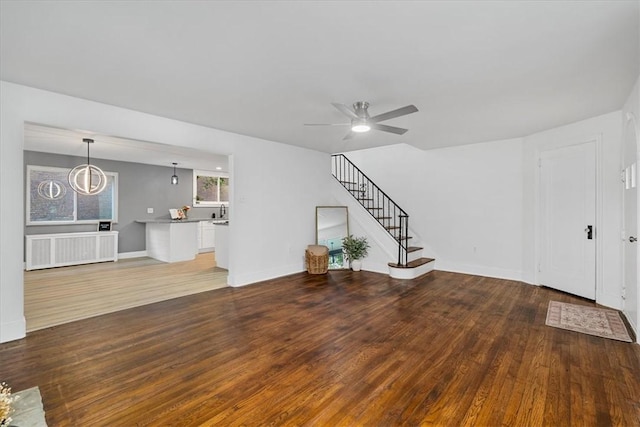 7032 Reynolds St, Point Breeze, PA 15208 - unfurnished living room with radiator, wood finished floors, ceiling fan, and stairs