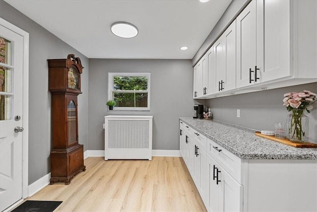 7032 Reynolds St, Point Breeze, PA 15208 - laundry area with radiator heating unit, light wood-style floors, and recessed lighting