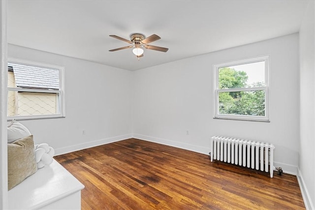 7032 Reynolds St, Point Breeze, PA 15208 - spare room featuring radiator heating unit, a ceiling fan, and wood finished floors