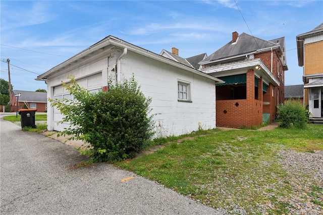 340 Weldon St, Latrobe, PA 15650 - view of side of home featuring an attached garage and a chimney