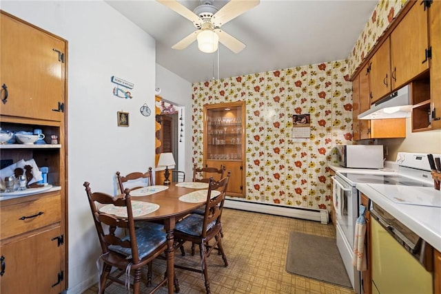 340 Weldon St, Latrobe, PA 15650 - kitchen featuring under cabinet range hood, white range with electric stovetop, wallpapered walls, a baseboard radiator, and light countertops