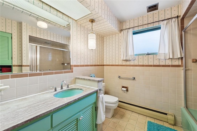 340 Weldon St, Latrobe, PA 15650 - full bath featuring wallpapered walls, a baseboard heating unit, tile walls, vanity, and wainscoting