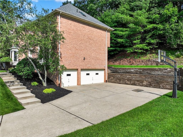408 Bryn Ct, Ross Twp, PA 15237 - view of side of property with a garage, concrete driveway, stucco siding, brick siding, and stairs