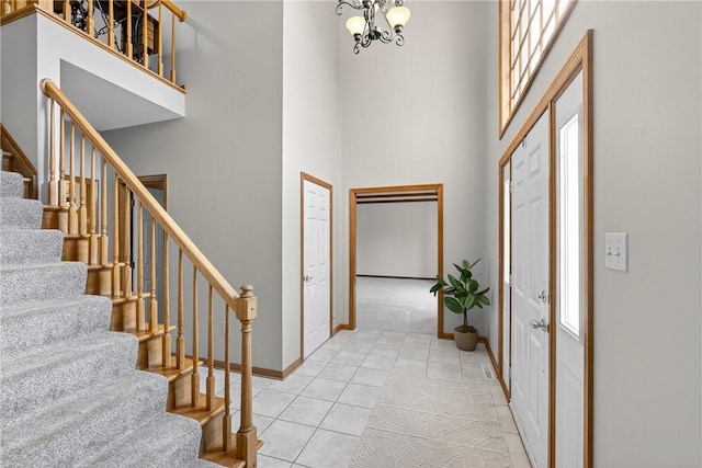 408 Bryn Ct, Ross Twp, PA 15237 - entryway featuring a towering ceiling, stairway, a chandelier, and light tile patterned flooring
