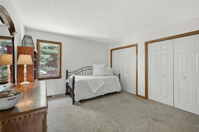 408 Bryn Ct, Ross Twp, PA 15237 - carpeted bedroom featuring two closets and multiple windows