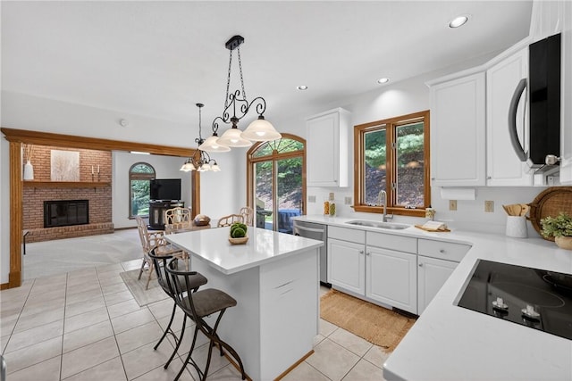 408 Bryn Ct, Ross Twp, PA 15237 - kitchen with stainless steel appliances, light tile patterned floors, a kitchen island, light countertops, and white cabinetry