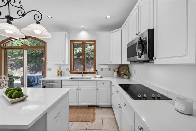 408 Bryn Ct, Ross Twp, PA 15237 - kitchen featuring appliances with stainless steel finishes, light countertops, light tile patterned floors, white cabinets, and recessed lighting
