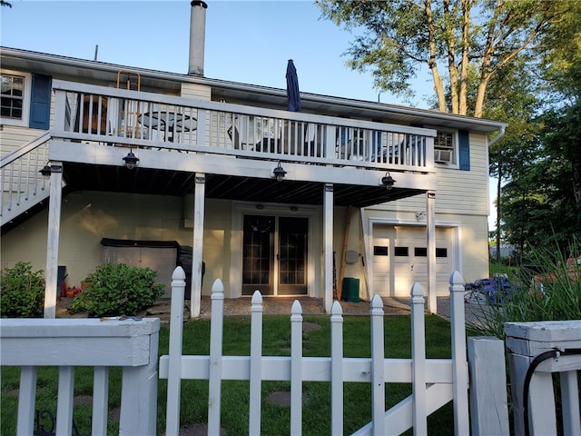 169 Orchard Dr, Brighton Twp, PA 15009 - back of property with a fenced front yard, an attached garage, a wooden deck, and driveway