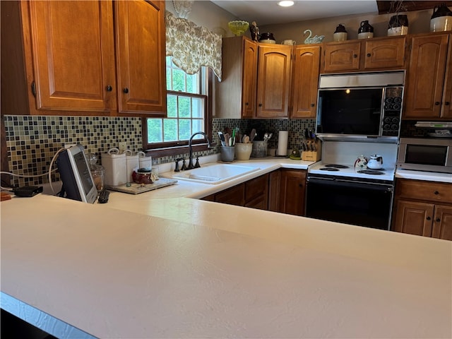 169 Orchard Dr, Brighton Twp, PA 15009 - kitchen featuring electric stove, stainless steel microwave, light countertops, decorative backsplash, and recessed lighting