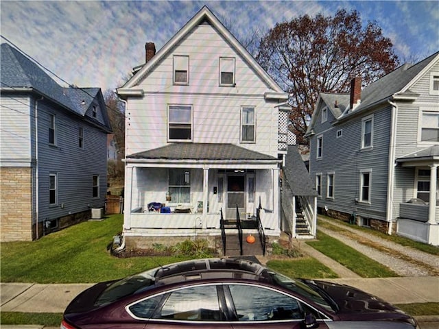 618 W Penn St, City Of But Nw, PA 16001 - american foursquare style home featuring covered porch, a front yard, a chimney, and stairs
