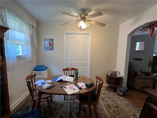 1104 Jefferson St, Mckeesport, PA 15132 - dining room featuring arched walkways, ceiling fan, and wood finished floors